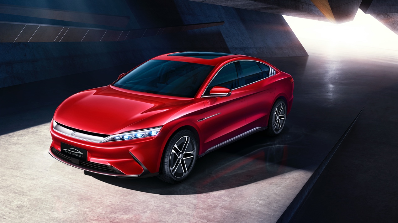 A red car parked in a parking lotDescription automatically generated